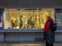 An elderly woman admires the festive Christmas window display in Munich, Bavaria, Germany, on December 11, 2024. The window features a Chris...