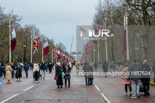 People walk along The Mall, decorated with Union Jack flags, in London, United Kingdom, on December 7, 2024 