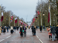 People walk along The Mall, decorated with Union Jack flags, in London, United Kingdom, on December 7, 2024 (