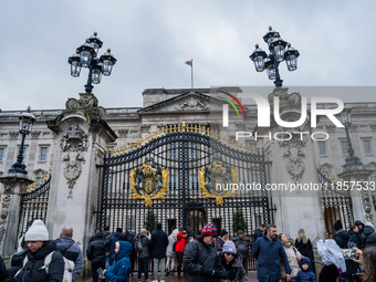 Visitors gather outside the gates of Buckingham Palace, in London, United Kingdom, on December 7, 2024. (