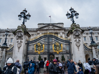 Visitors gather outside the gates of Buckingham Palace, in London, United Kingdom, on December 7, 2024. (