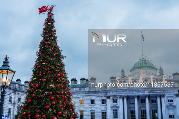 People gather around the Christmas tree at Somerset House, in London, United Kingdom, on December 7, 2024 