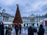 People admire the Christmas tree at Somerset House, in London, United Kingdom, on December 7, 2024 (