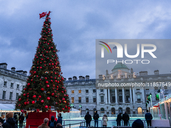 People admire the Christmas tree at Somerset House, in London, United Kingdom, on December 7, 2024 (