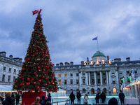 People admire the Christmas tree at Somerset House, in London, United Kingdom, on December 7, 2024 (