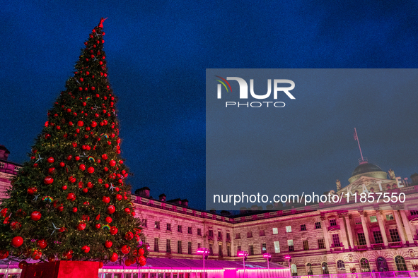 People admire the Christmas tree at Somerset House, in London, United Kingdom, on December 7, 2024 