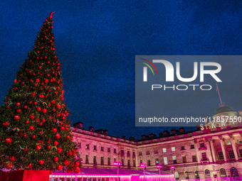 People admire the Christmas tree at Somerset House, in London, United Kingdom, on December 7, 2024 (