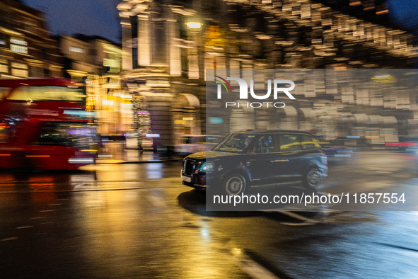 A taxi travels through the streets of London, United Kingdom, on December 7, 2024 