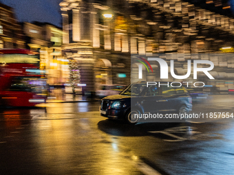 A taxi travels through the streets of London, United Kingdom, on December 7, 2024 (