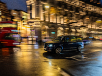 A taxi travels through the streets of London, United Kingdom, on December 7, 2024 (