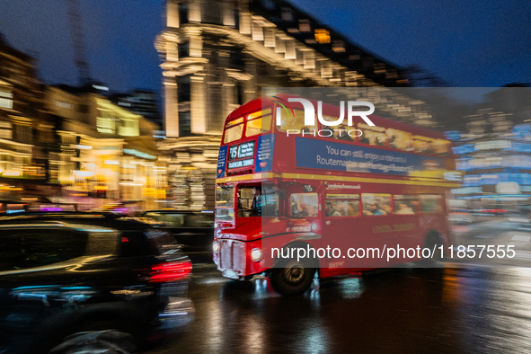 A red double-decker bus travels through the streets of London, United Kingdom, on December 7, 2024 