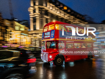 A red double-decker bus travels through the streets of London, United Kingdom, on December 7, 2024 (