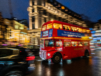 A red double-decker bus travels through the streets of London, United Kingdom, on December 7, 2024 (