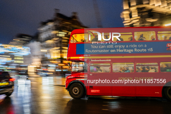 A red double-decker bus travels through the streets of London, United Kingdom, on December 7, 2024 