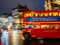 A red double-decker bus travels through the streets of London, United Kingdom, on December 7, 2024 (