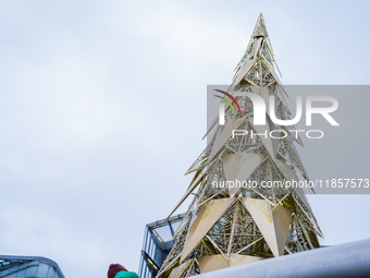 Visitors admire a modern Christmas tree installation near City Hall, in London, United Kingdom, on December 8, 2024 (