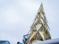 Visitors admire a modern Christmas tree installation near City Hall, in London, United Kingdom, on December 8, 2024 (