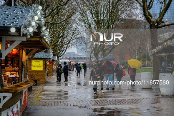 Visitors walk with umbrellas along a wet South Bank during Storm Darragh on December 7, 2024, in London, United Kingdom. London's Royal Park...