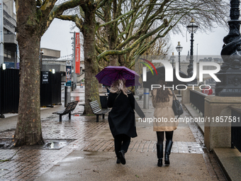 Two women walk under umbrellas along the South Bank during Storm Darragh on December 7, 2024, in London, United Kingdom  London's Royal Park...