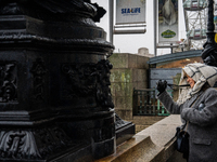 A woman with scarf and coat photographs a scene near the London Eye during Storm Darragh on December 7, 2024, in London, United Kingdom. Lon...