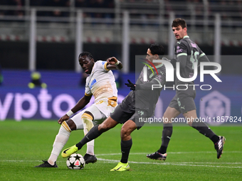 Cherif Ndiaye of FK Crvena Zvezda and Tijjani Reijnders of AC Milan battle for the ball during the UEFA Champions League match between AC Mi...