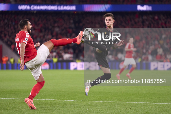 Vangelis Pavlidis of SL Benfica competes for the ball with Kacper Urbanski of Bologna Football Club 1909 during the UEFA Champions League ma...