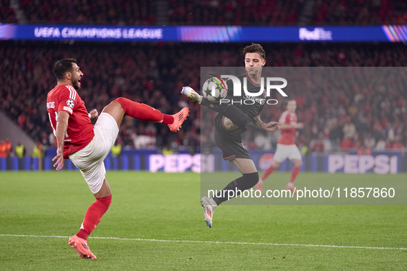 Vangelis Pavlidis of SL Benfica competes for the ball with Kacper Urbanski of Bologna Football Club 1909 during the UEFA Champions League ma...