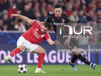 Nikola Moro of Bologna Football Club 1909 competes for the ball with Orkun Kokcu of SL Benfica during the UEFA Champions League match betwee...