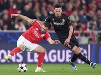 Nikola Moro of Bologna Football Club 1909 competes for the ball with Orkun Kokcu of SL Benfica during the UEFA Champions League match betwee...