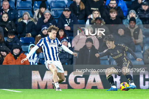 #4, Callum Styles of WBA defends as #7, Tatsuhiro Sakamoto of Coventry turns inside him to press the attack during the Sky Bet Championship...