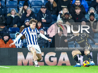 #4, Callum Styles of WBA defends as #7, Tatsuhiro Sakamoto of Coventry turns inside him to press the attack during the Sky Bet Championship...