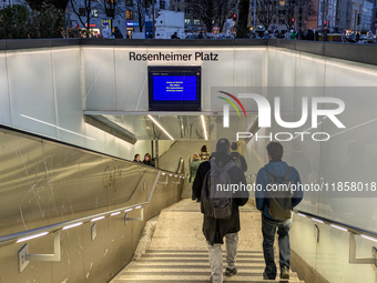 Commuters and pedestrians descend the steps into Rosenheimer Platz suburban train station in Munich, Bavaria, Germany, on December 11, 2024....