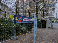 Seasonal tree sales take place in a bustling Bavarian square. In Munich, Bavaria, Germany, on December 11, 2024, a small Christmas tree mark...