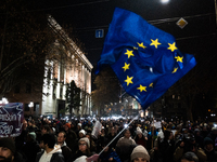 Georgian pro-Europe demonstrators gather during a protest against the government's postponement of European Union accession talks until 2028...