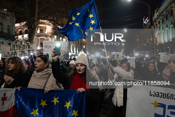 Georgia pro-Europe demonstrators hold the European flag during a protest against the government's postponement of European Union accession t...