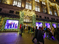 People walk past the entrance of Saks Fifth Avenue in New York, N.Y., on December 10, 2024. (