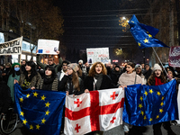 Georgia pro-Europe demonstrators hold Georgian and European flags during a protest against the Government's postponement of European Union a...