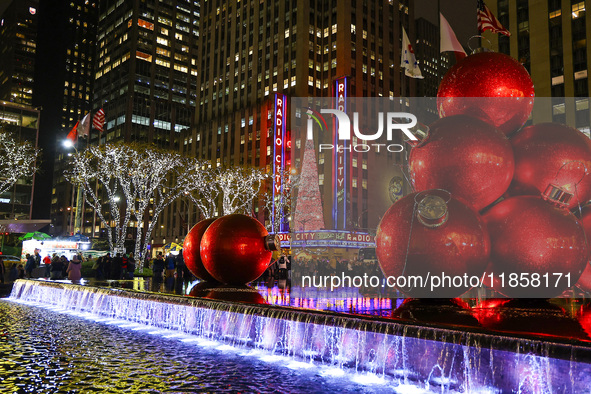 Giant Christmas ornaments rest in the fountain across the street from Radio City Music Hall in New York, N.Y., on December 10, 2024. 