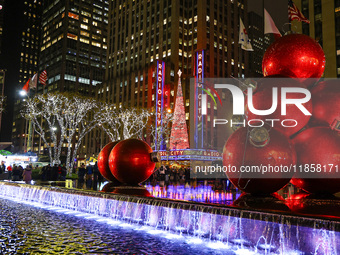 Giant Christmas ornaments rest in the fountain across the street from Radio City Music Hall in New York, N.Y., on December 10, 2024. (