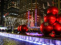 Giant Christmas ornaments rest in the fountain across the street from Radio City Music Hall in New York, N.Y., on December 10, 2024. (