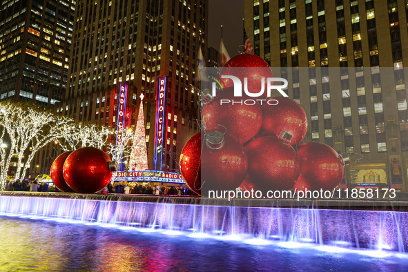 Giant Christmas ornaments rest in the fountain across the street from Radio City Music Hall in New York, N.Y., on December 10, 2024. 