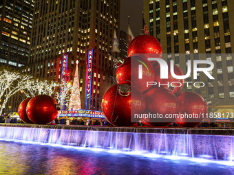 Giant Christmas ornaments rest in the fountain across the street from Radio City Music Hall in New York, N.Y., on December 10, 2024. (