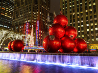 Giant Christmas ornaments rest in the fountain across the street from Radio City Music Hall in New York, N.Y., on December 10, 2024. (