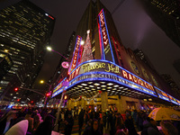 The Christmas tree made of lights stands on the marquee of Radio City Music Hall with the Rockefeller Center illuminated in the background i...