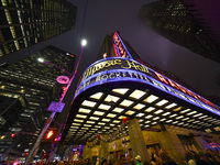 The Christmas tree made of lights stands on the marquee of Radio City Music Hall with the Rockefeller Center illuminated in the background i...