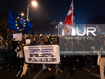 Georgia pro-Europe demonstrators hold Georgian and European flags during a protest against the Government's postponement of European Union a...