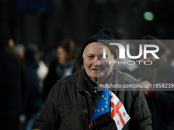 Georgian pro-Europe demonstrators gather during a protest against the government's postponement of European Union accession talks until 2028...