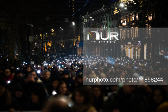 Georgian pro-Europe demonstrators march during a protest against the Government's postponement of European Union accession talks until 2028,...