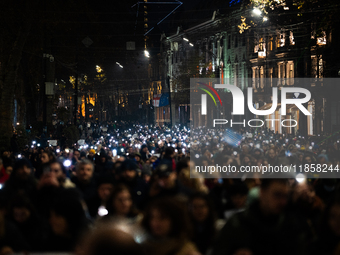 Georgian pro-Europe demonstrators march during a protest against the Government's postponement of European Union accession talks until 2028,...