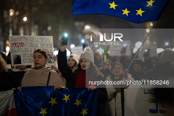 Georgia pro-Europe demonstrators hold Georgian and European flags during a protest against the Government's postponement of European Union a...